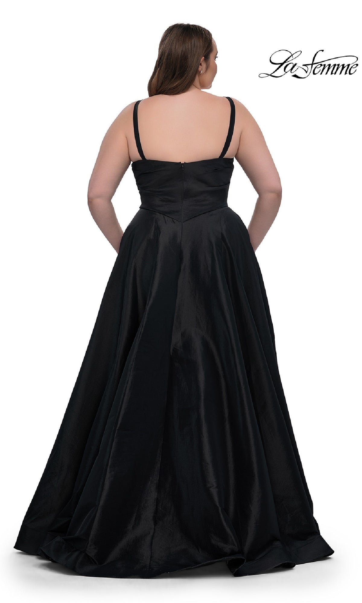 Shown from the back against a white background, a woman models the La Femme 33075 Long Plus-Size Prom Dress—a black, floor-length gown featuring thin straps and an elegant a-line skirt.